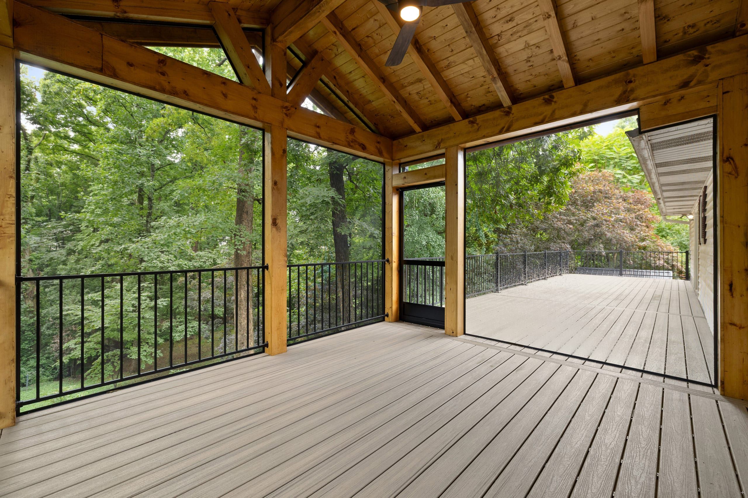 Venice covered screened porch with vaulted cedar tongue-and-groove ceiling opening onto an elevated composite deck