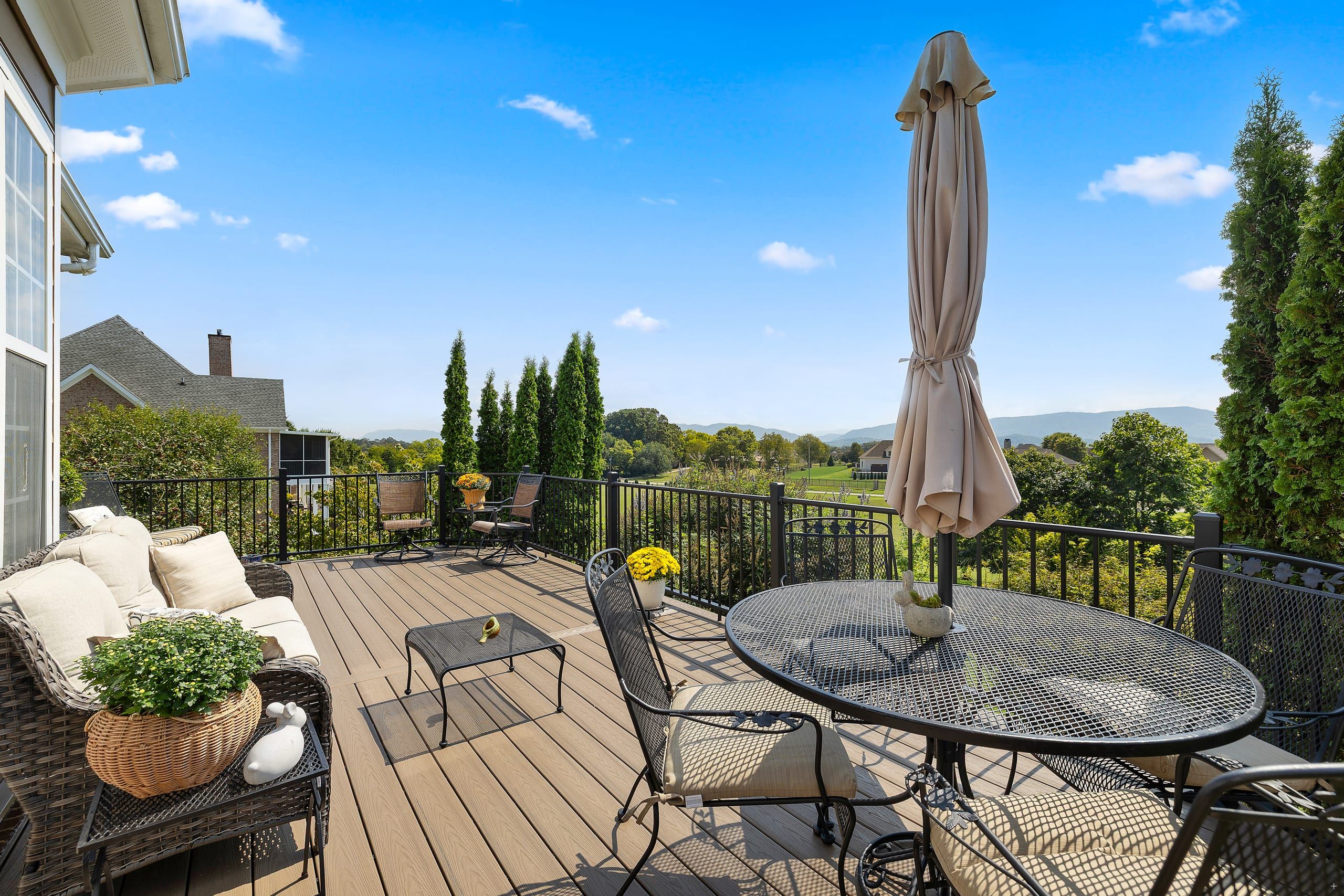 Whittenburg Deckorators Venture composite deck with black aluminum railing and a mountain view