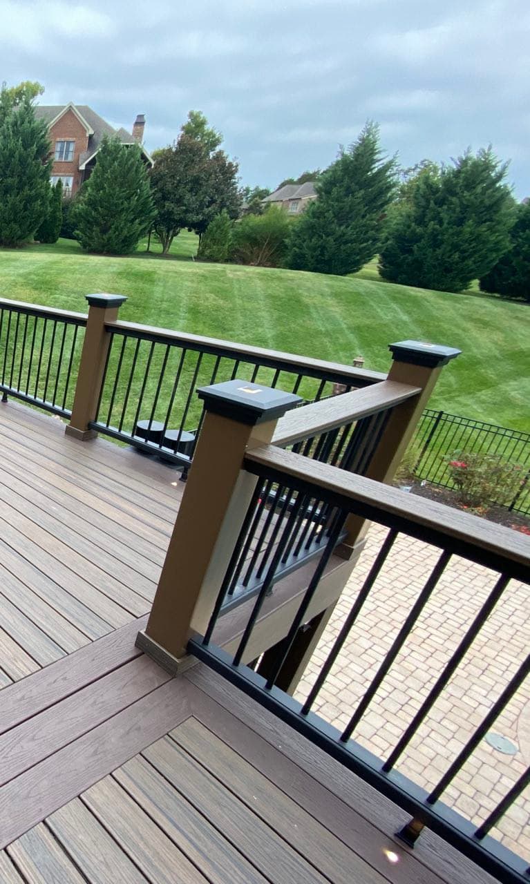 Vinyl-wrapped pressure treated railing with Trex composite top rail and black powder-coated stainless steel balusters